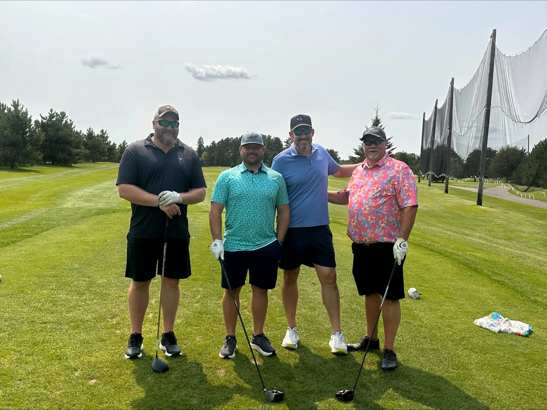 Four Team Twin Cities members together at a golf outing