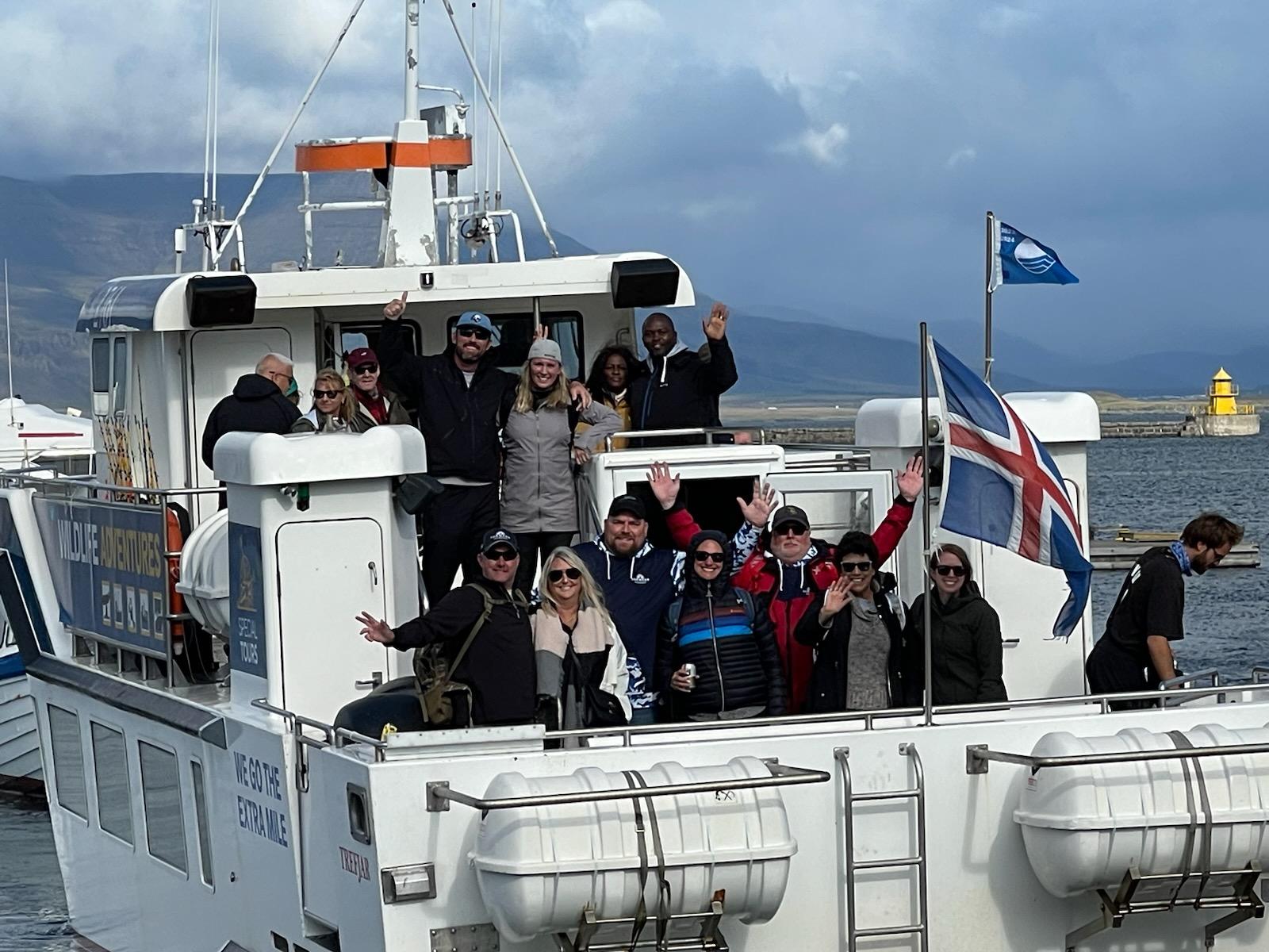 Team members gathered on a sailing boat