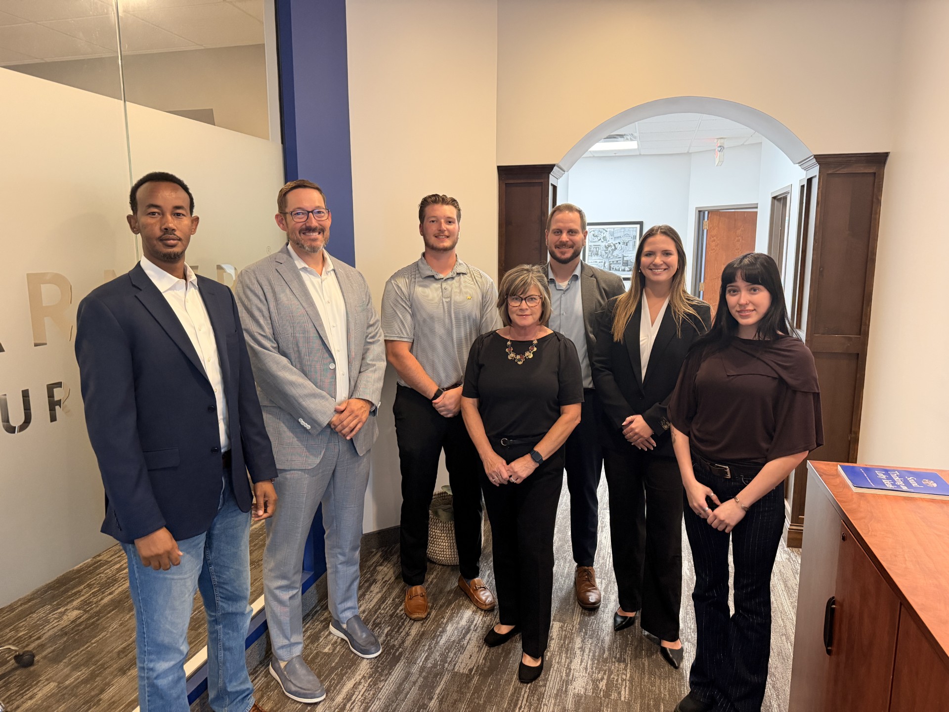 Seven Team Twin Cities colleagues gathered in the Woodbury office