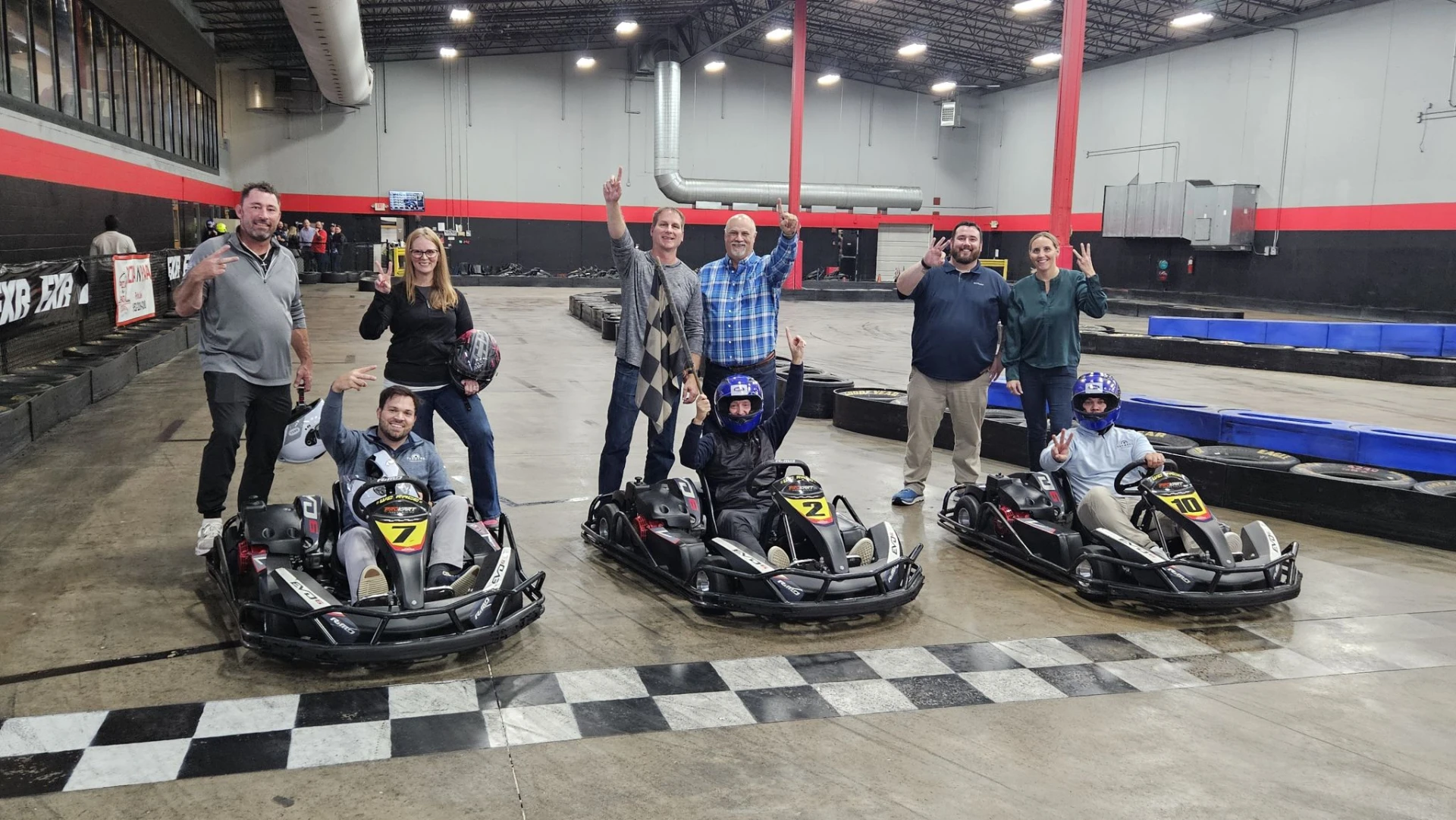 Team Twin Cities members celebrating together after go-kart racing